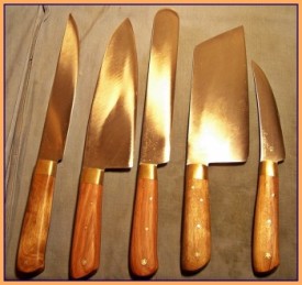 A BASIC SET SENT TO AUSTRALIA, which was DESIGNED BY THE CLIENT. HE SENT ME Jarrah WOOD FROM AUSTRALIA . CARBON STEEL, BRASS BOLSTERS. LEFT TO RIGHT: 8″ X 1.25″ KOREAN KITCHEN KNIFE, 8″ SANTOKU, 9″ BLUNT TIPPED SLICER, 8″ X 3″ THAI CLEAVER USING 3/32″ 1095 TOOL STEEL, AND LASTLY A 6″ SCIMITAR SHAPED BONING KNIFE.
